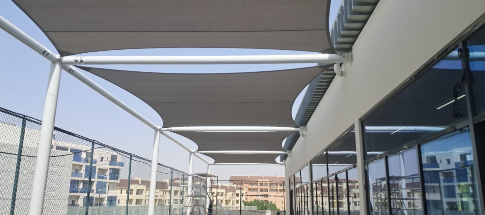 Tensile walkway canopy installed by Al Laaiq Shades