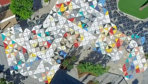 Aerial view of a multicoloured triangular panel canopy