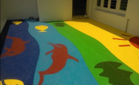 Rubber flooring with dolphins on green, yellow and blue bands